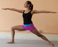 woman doing warrior pose in Kalon yoga shorts